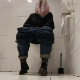 A woman who does not show her face takes a shit while sitting on a toilet mounted to the wall. She wipes her ass when finished. Presented in 720P HD. Over 5.5 minutes.